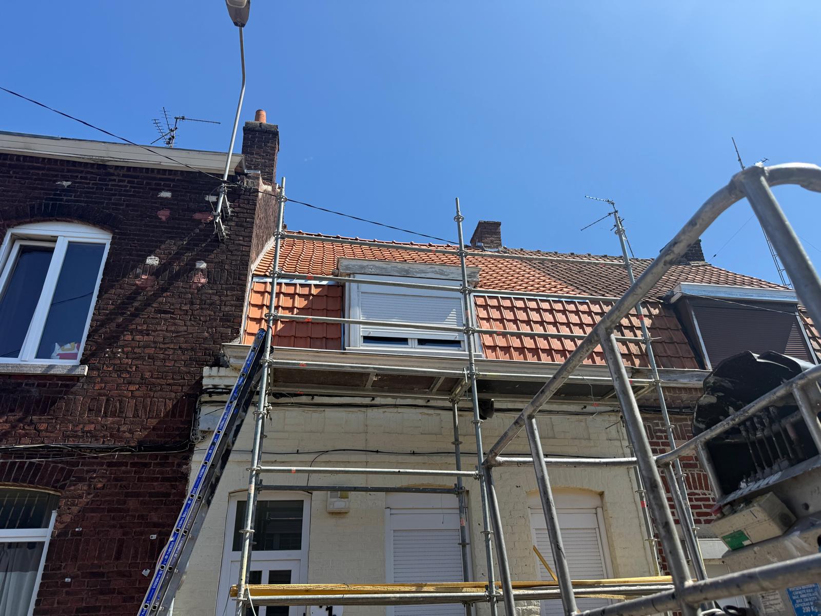 Façade brique avec échafaudage MG Toiture, toiture tuiles orange neuves en cours de pose